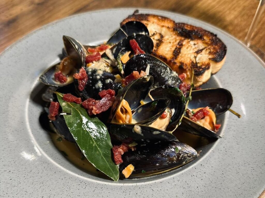 Fresh local mussels with garlic, shallots, pancetta in a creamy white wine sauce. Served with ciabatta.